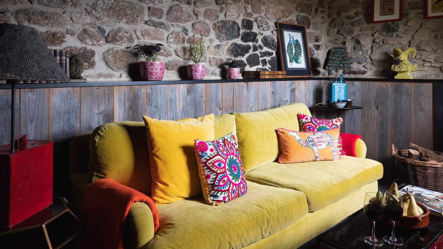 Curl up on the canary yellow sofa, bedecked with flamboyant embroidered cushions
