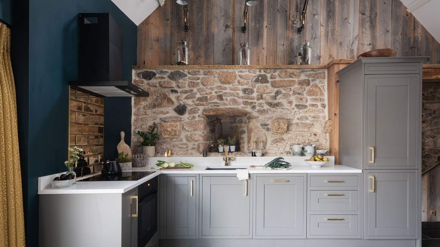 Prepare indulgent meals a deux in the fully equipped kitchen, with soothing grey units and stunning gold accents