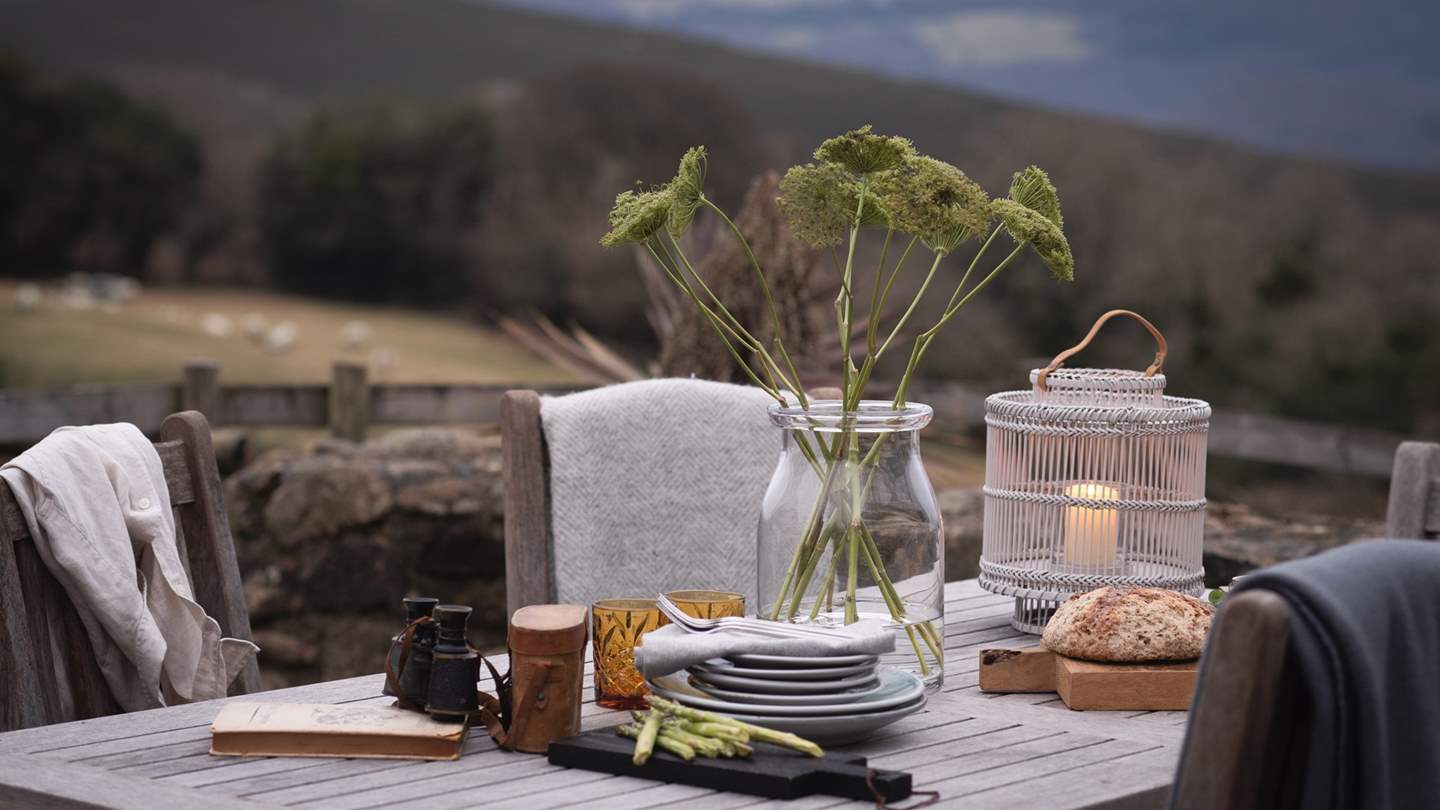 Watch the skies turn from day to dusk as you relax by the teak dining table 