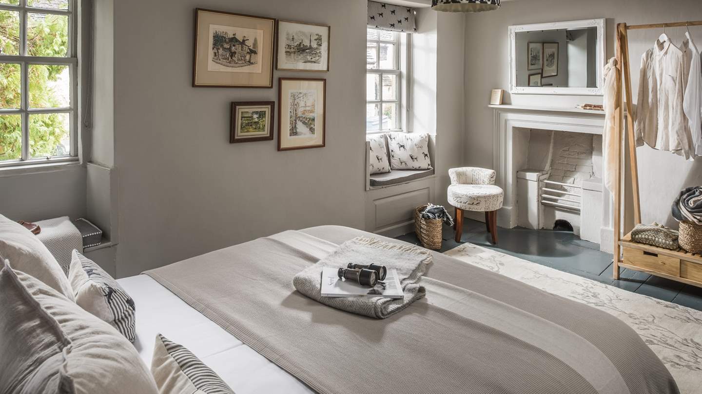 Complementing the scene are twin window seats, an authentic feature fireplace, and attractive furnishings