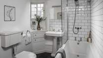 Situated next to the second bedroom is our retreat’s main bathroom, complete with a bath with an overhead shower