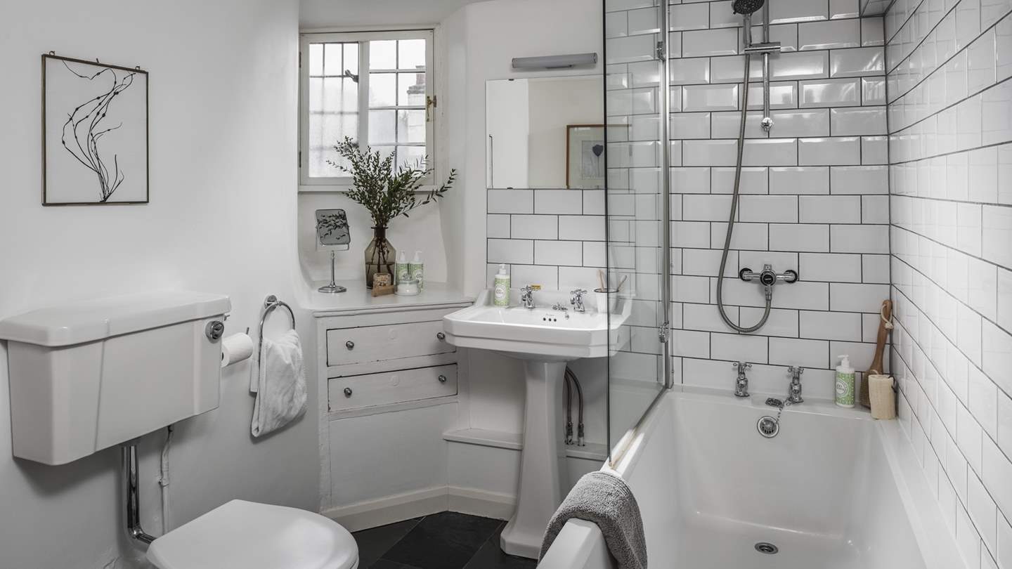 Situated next to the second bedroom is our retreat’s main bathroom, complete with a bath with an overhead shower