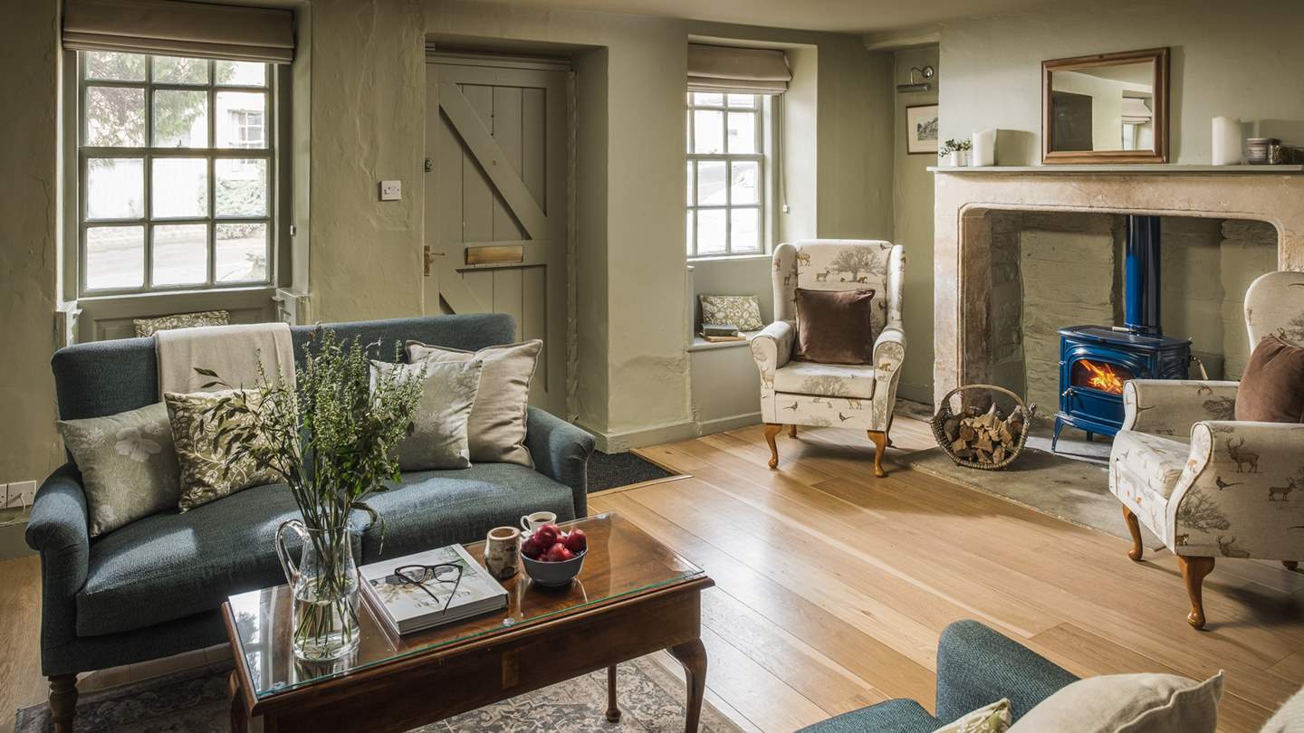 The living area boasts sage tones complemented with country prints