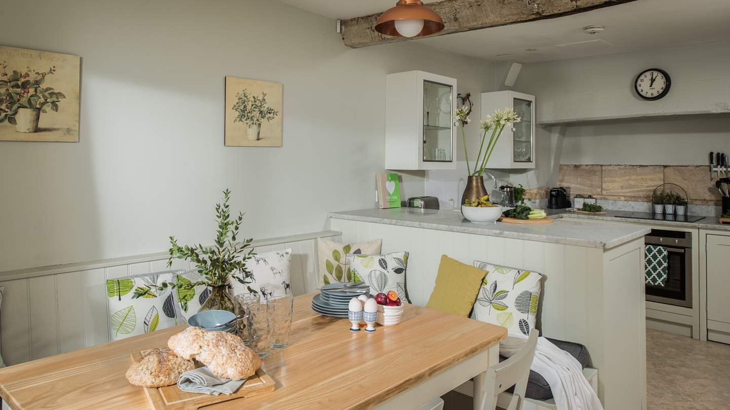 Pairing the same beautiful sage hues as the lounge, the open-plan kitchen and dining room is the heart of the home