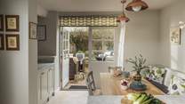 With French doors opening onto an enclosed courtyard garden, it brings the outside in on sunny days for idyllic country living