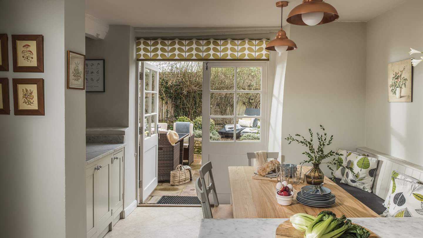 With French doors opening onto an enclosed courtyard garden, it brings the outside in on sunny days for idyllic country living