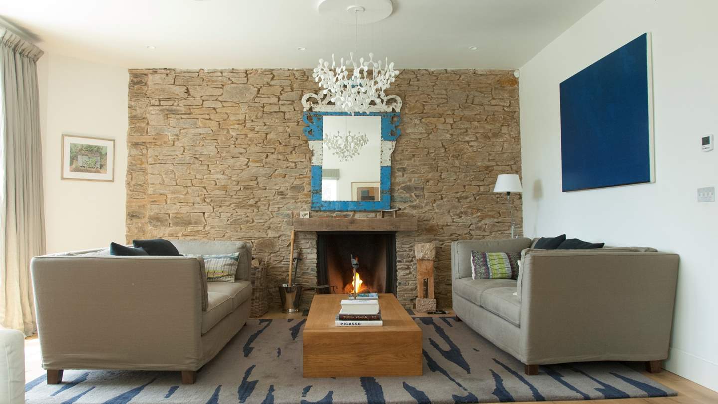The sitting room has a traditional open fire and the walls are adorned with modern art