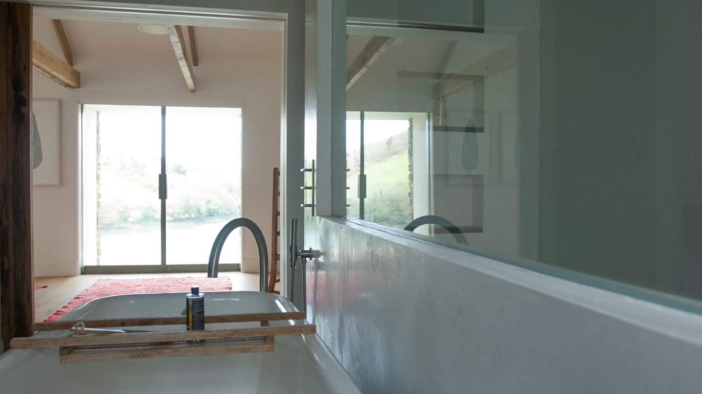 The en suite with shower and bath, in which you can soak and admire the beautiful view beyond