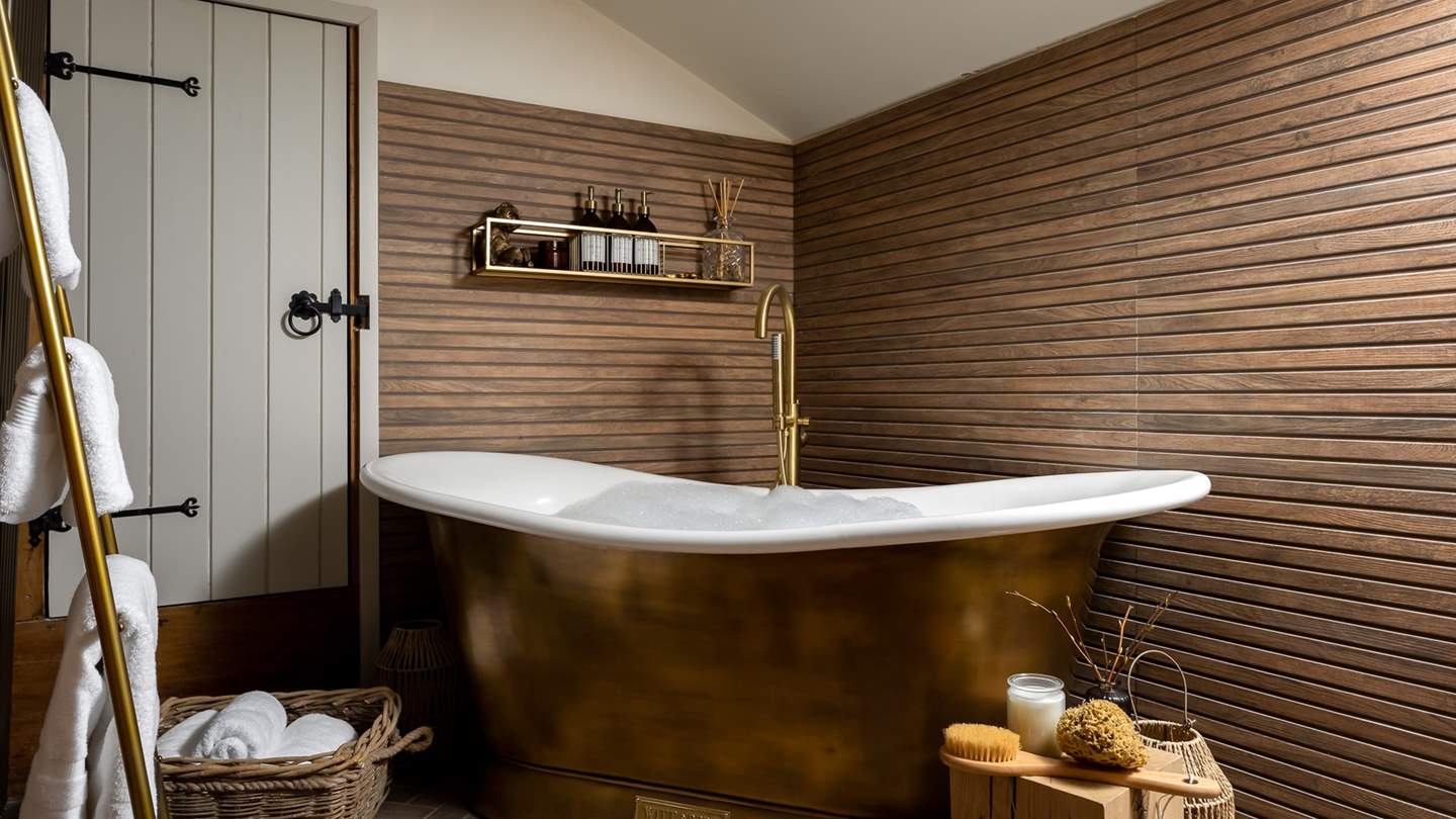 Savour sumptuous soaks in the sensational Witt & Berg antique brass rolltop bath 
