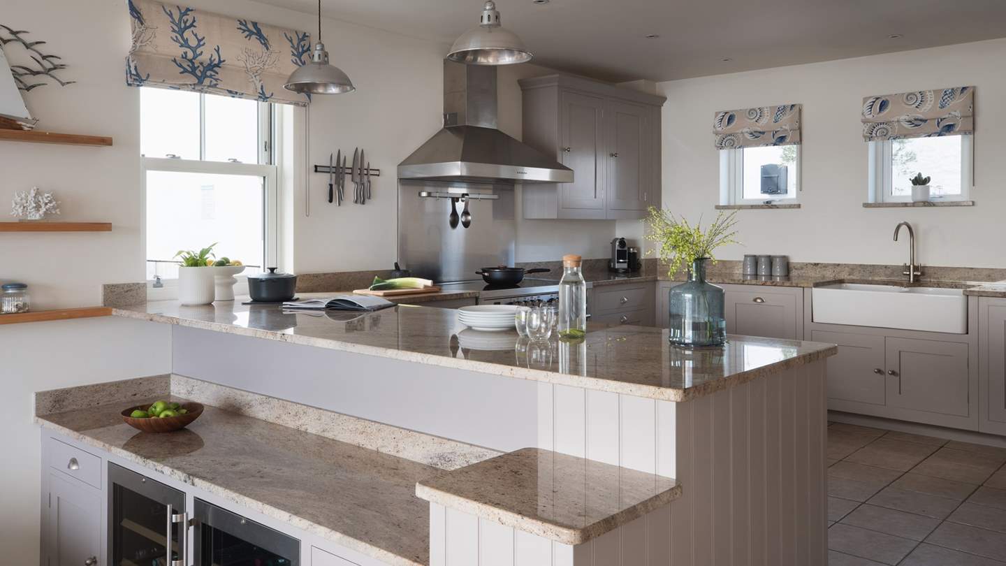 On the kitchen’s lower level, you will find a sleek bar space, with two fridges to ensure wine is kept perfectly crisp