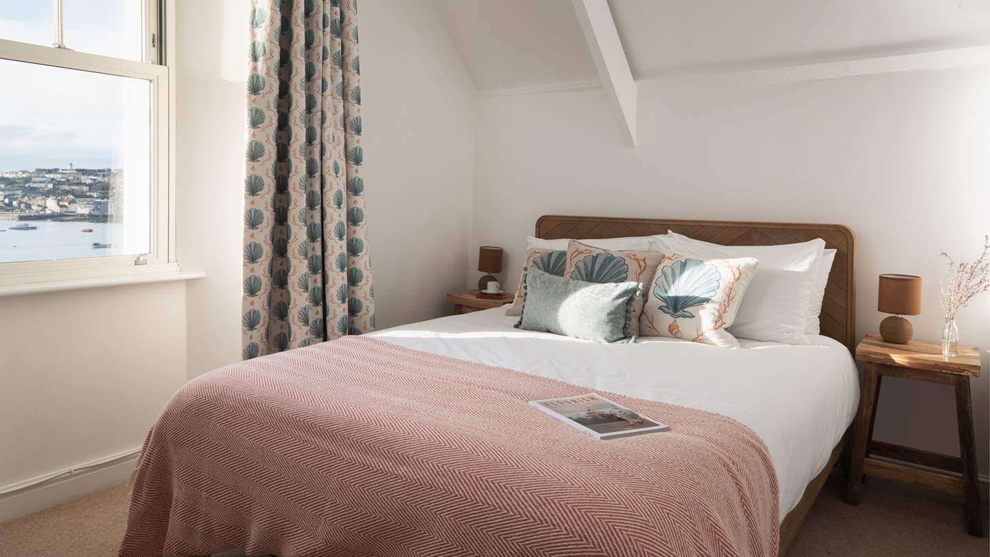 Bedroom five lies on the top floor, with wonderful views across the River Fal