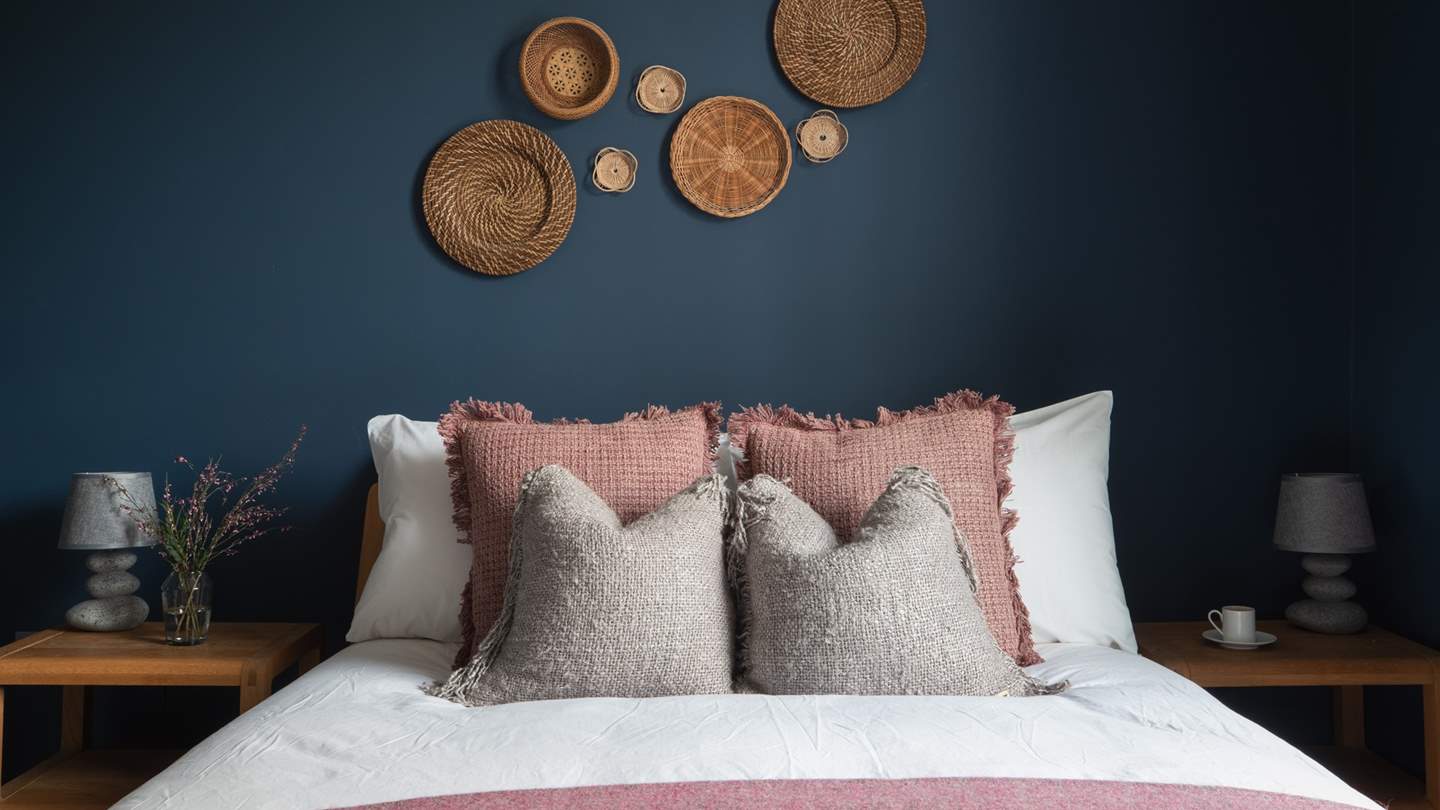 This bedroom features a comfy king-sized bed and a spacious wardrobe for storage