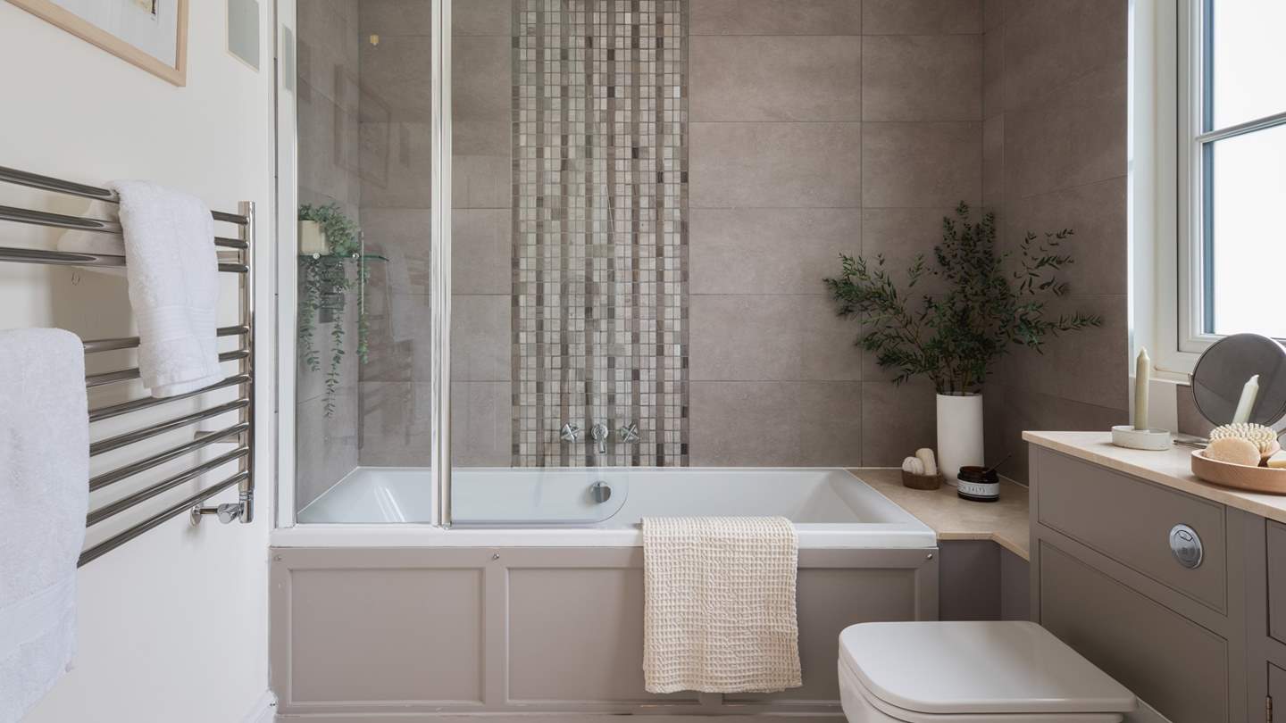 The master bedroom has a beautiful ensuite bathroom in calming neutral tones 