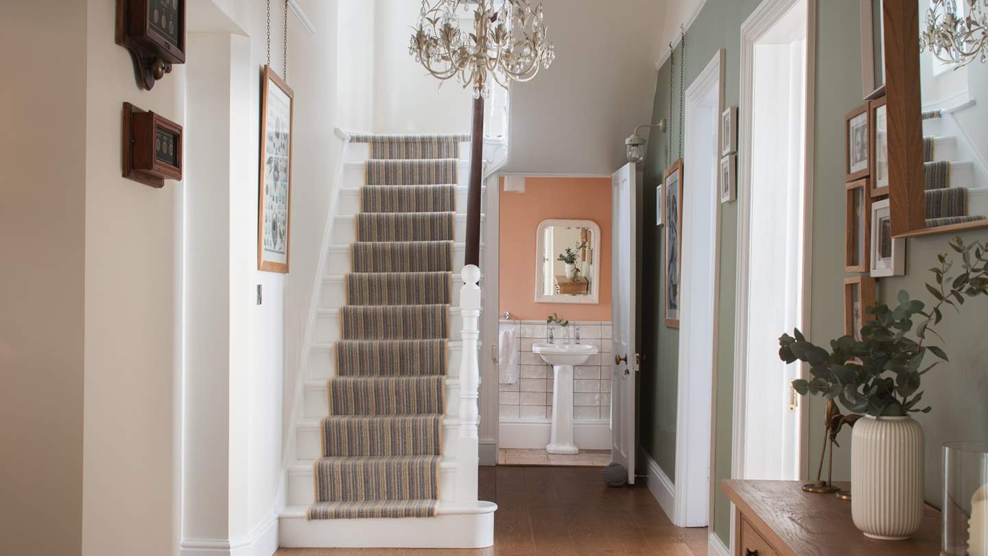 On the ground floor, there is a downstairs loo, with pretty peach finishing touches and soft, white tiles
