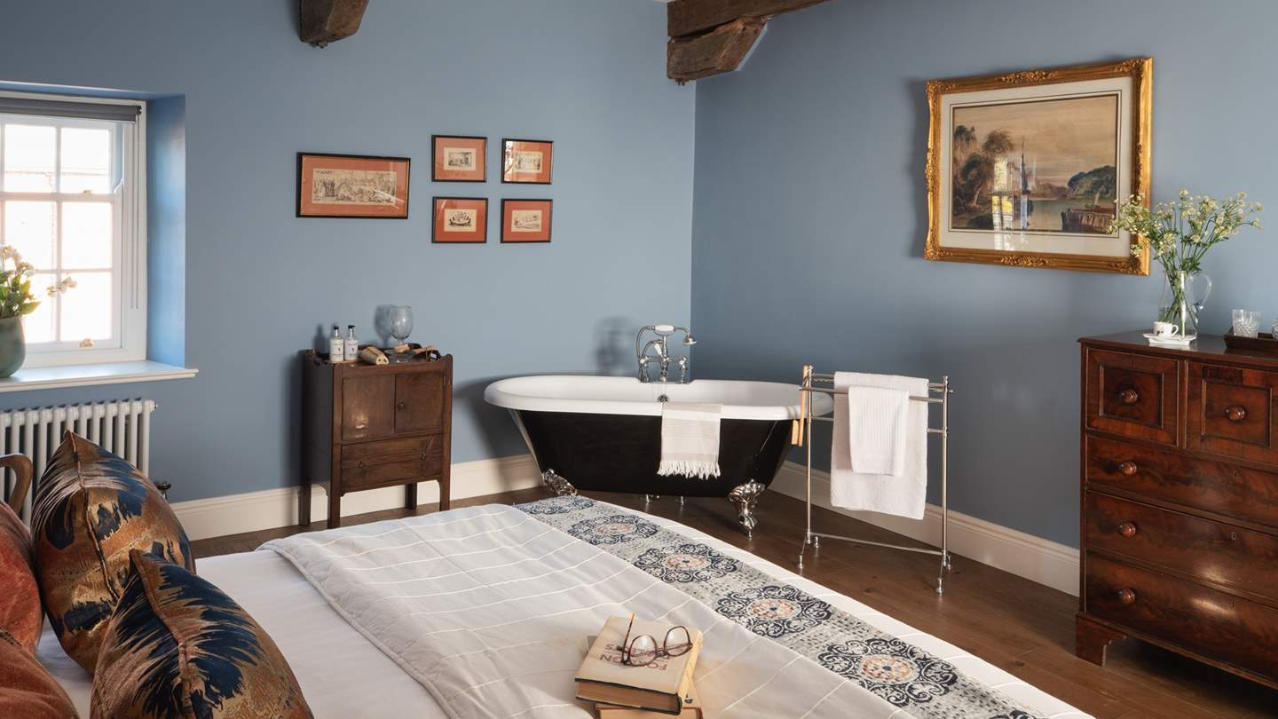 A beautiful rolltop bath resides for bubble-topped soaks