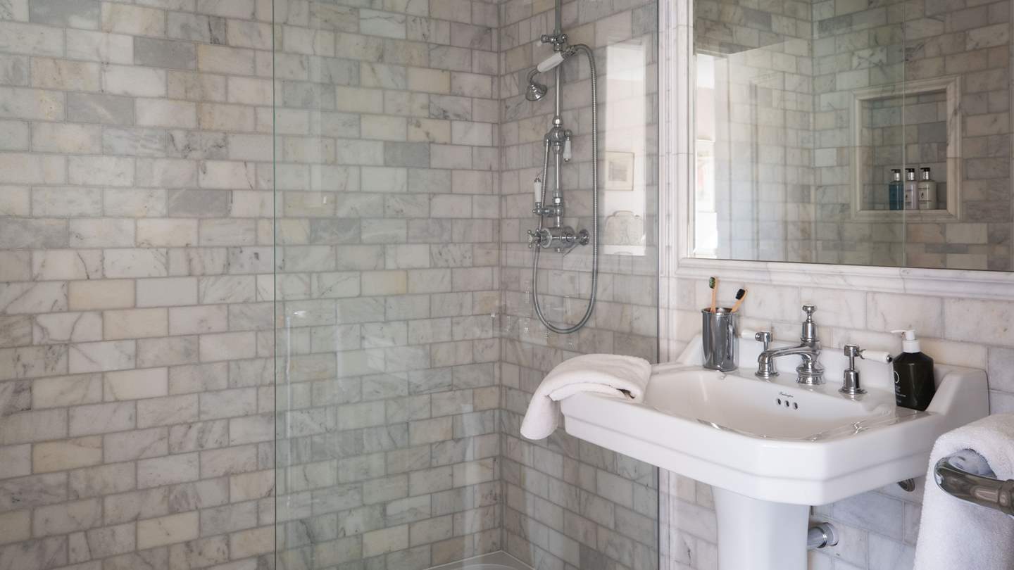 Benefitting from its own ensuite bathroom with a gorgeous walk-in shower, decorated with marble tiles