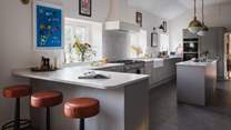 With a peninsula breakfast bar and kitchen island offering abundant space for preparing feasts