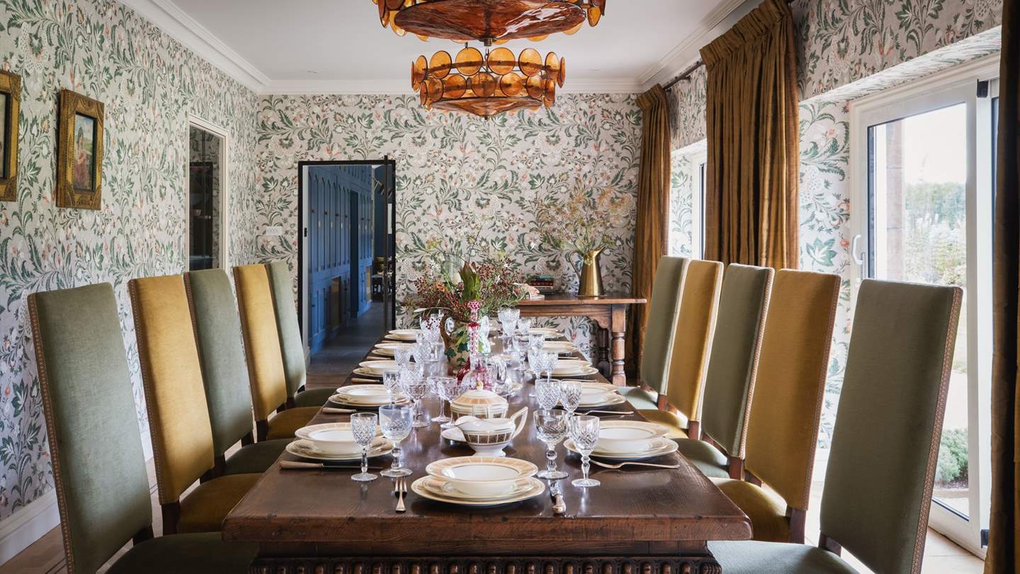 The formal dining room awaits with a grand table with seating for up to twelve