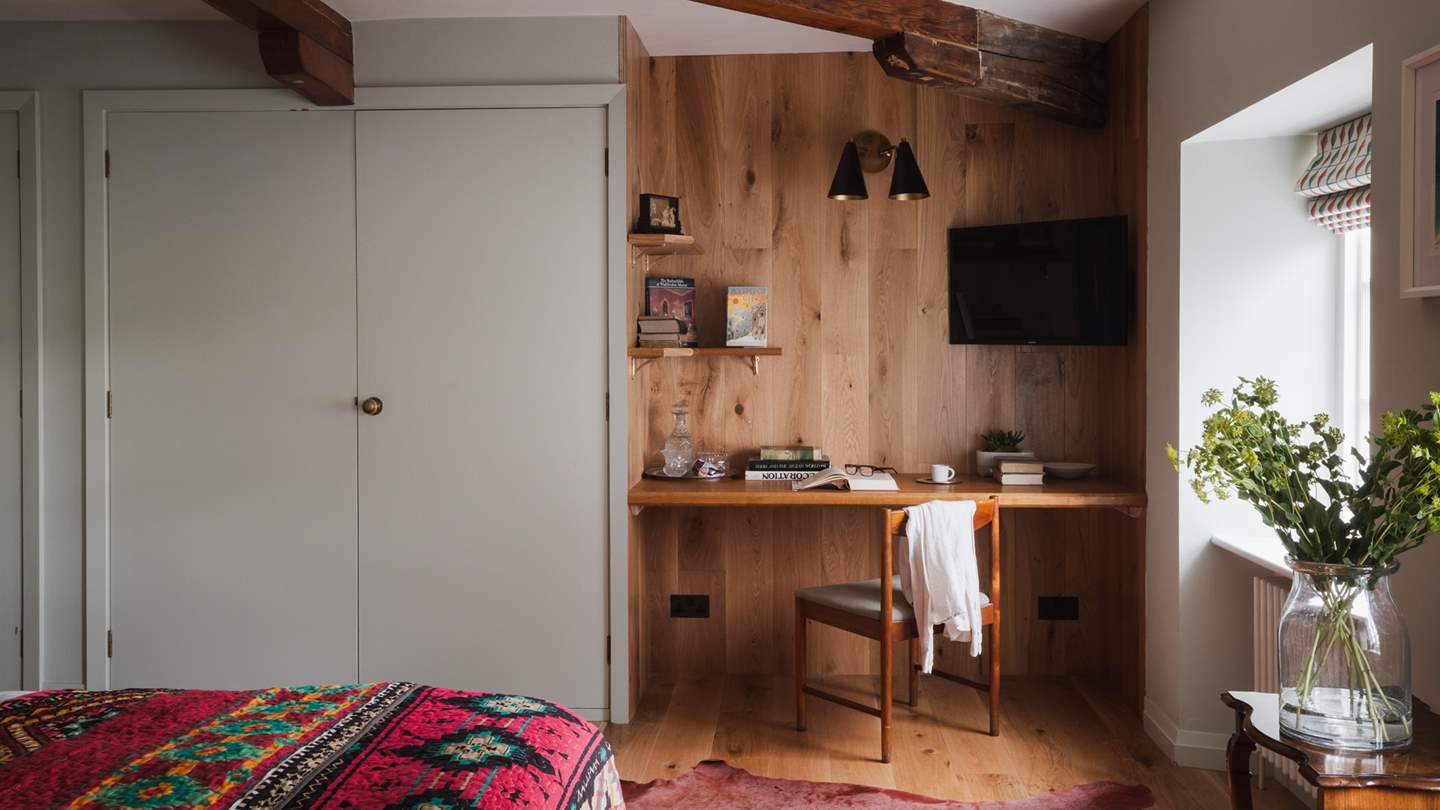 An integrated writing desk provides space for mindful expression, along with a wall-mounted TV for catching up on your current series