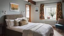 The sixth bedroom presents a peaceful idyll, decorated in a calming, neutral palette