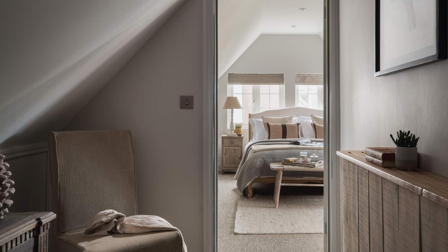 The romantic master bedroom with a vaulted ceiling promises a calming space for lingering lie-ins and moments of quietude