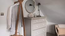 This room is complete with a chic chest of drawers and a quirky hanging rail
