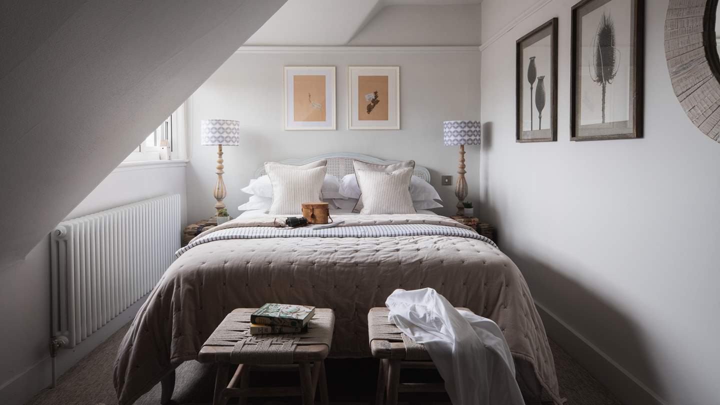 Adorned in neutral tones and pretty botanical artwork, bedroom three is effortlessly stylish 