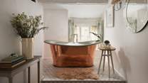 You'll find a soothing spa room complete with a stunning copper bathtub