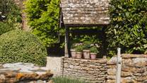 A sweet wishing well resides at the front of Laurel Cottage