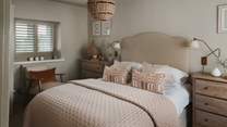 Sumptuous linens and soft-toned cushions and throws ensure a blissful night’s sleep at Laurel Cottage 