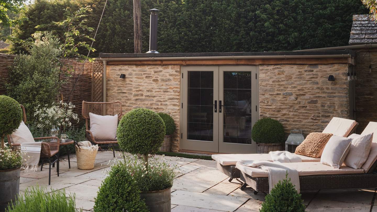 Step outside into the cute cottage garden, split over three levels with a sweet patio, verdant lawn and a delightful sun terrace