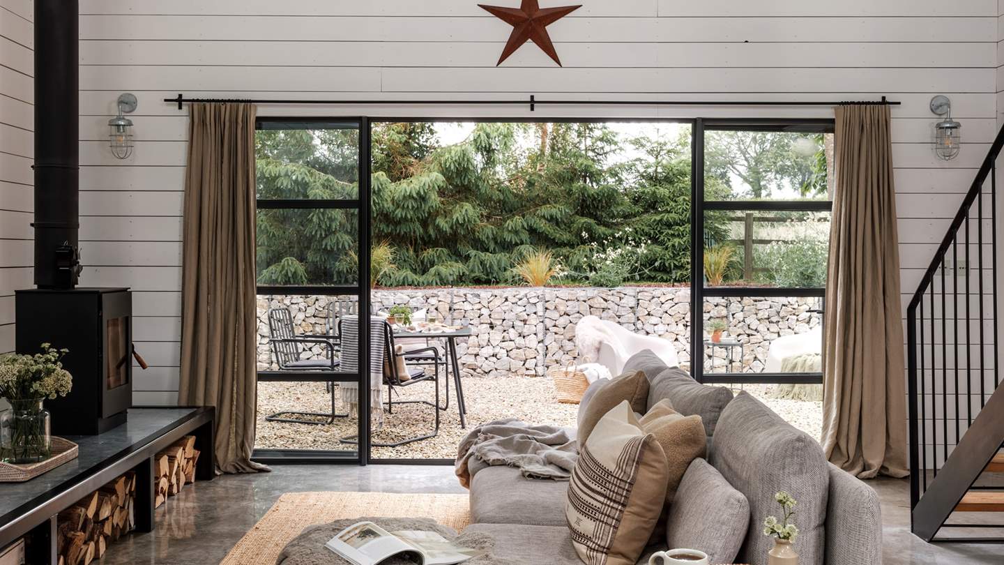 The epitome of calm, this space benefits from large Crittall-style doors and windows which bathe rustic features in golden light