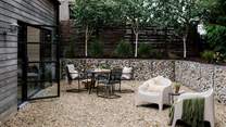 Just lovely for those slow-paced mornings and balmy evenings kissed by a low sun, the garden features a dining table and bench, two loungers and a firepit BBQ