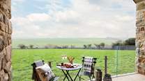 Reaching pastoral views wrap around the beautifully converted barn