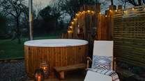 Light the wood-fired hot tub for a moment of bliss surrounded by the quiet glow of festoon lighting