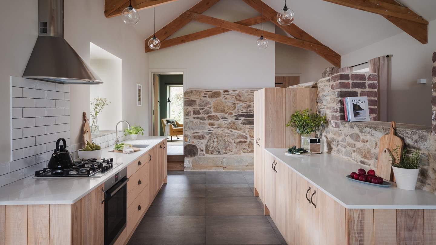 Two small steps lead you into the open plan dining and kitchen area, where culinary creations can be crafted and enjoyed