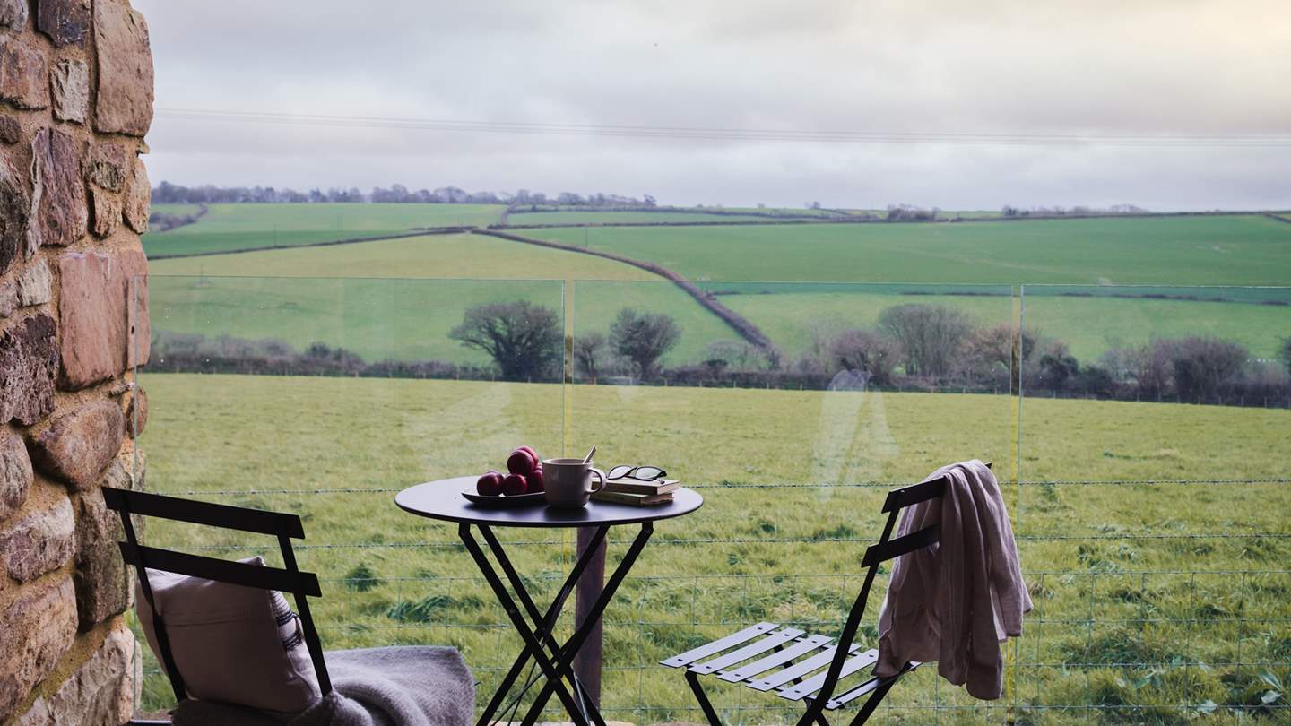 Reaching pastoral views wrap around the beautifully converted barn