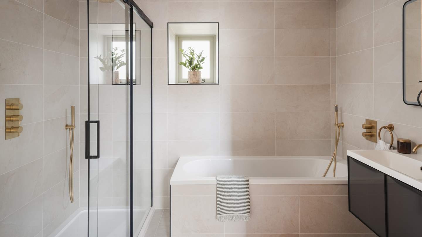 The main bathroom sits adjacent to the bedroom and offers a luxurious place to start and end your day 