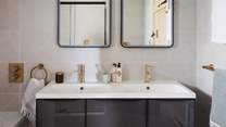 The dual vanity sink with self-lit mirrors are especially grand