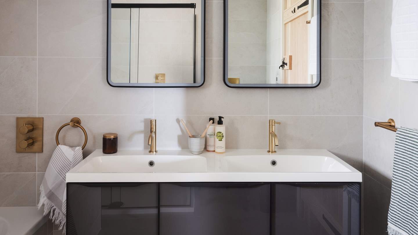 The dual vanity sink with self-lit mirrors are especially grand