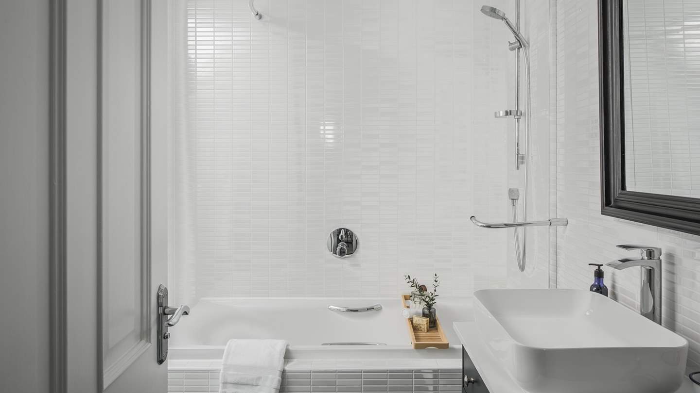 This delightful bedroom also benefits from an en suite bathroom with a bath and hand-held shower attachment