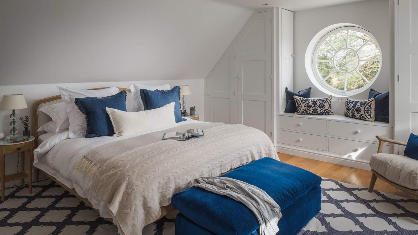 Set within a separate studio, bedroom eight has a super king-sized bed swathed in pure linens and hugged by bedside tables