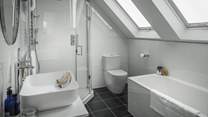 Like all of Arboretum's stunning bedrooms, this space has its own en suite bathroom, where a shower and bath await.