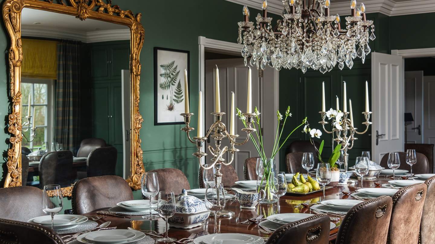 Taking pride of place in the centre of the room, a long mahogany table illuminated by a chandelier comfortably seats up to sixteen and invites for atmospheric feasts
