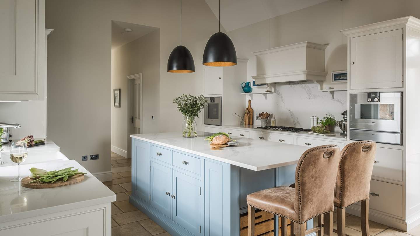 Running the length of the property and adjoined by a handy utility room, it is served by plentiful space, seating, and accoutrements 