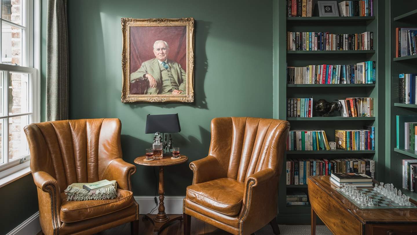 A tranquil space, complete with booklined shelves and two plump armchairs for moments lost between the pages