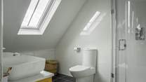 This en suite has a large shower and a vanity basin
