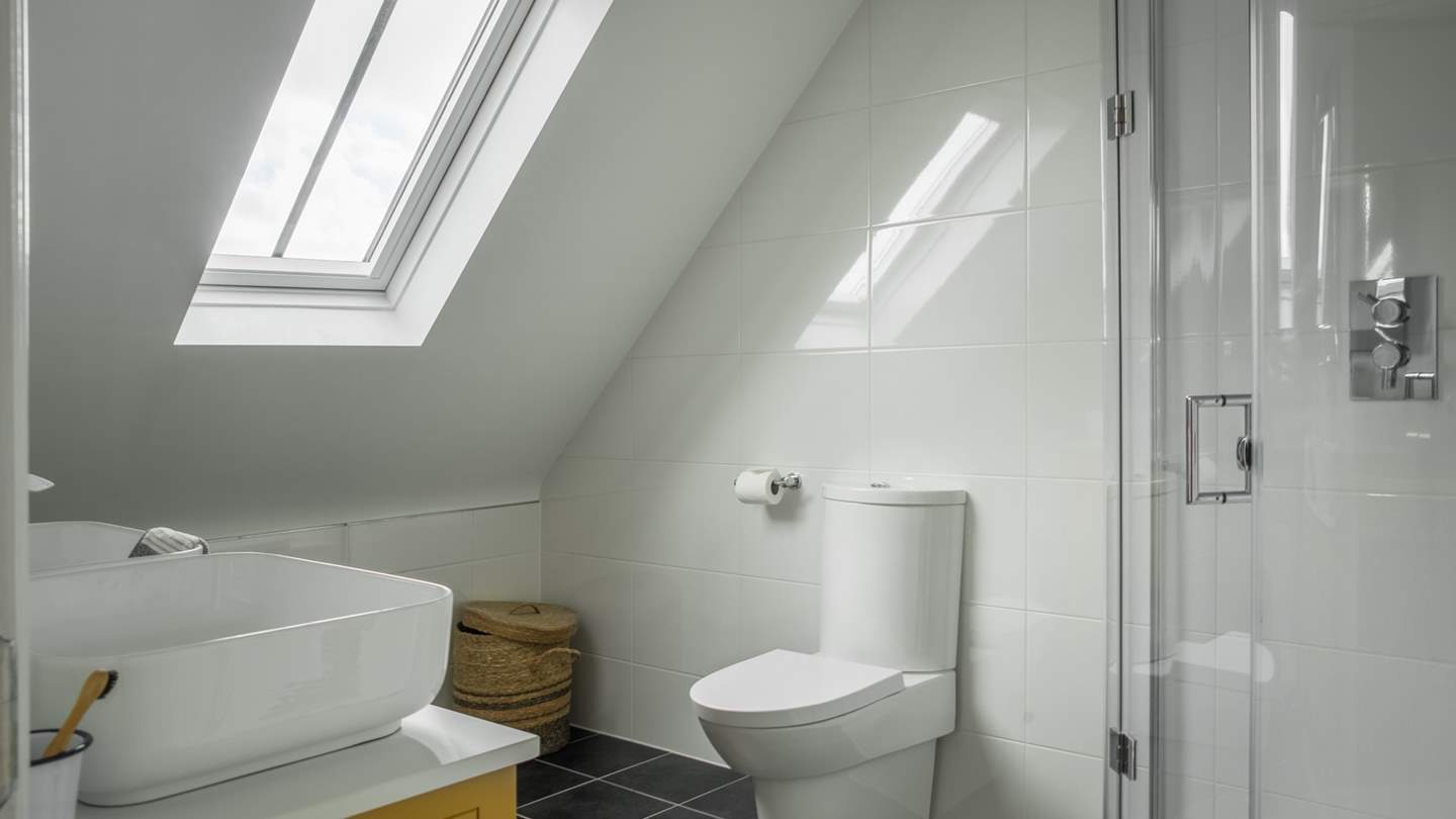 This en suite has a large shower and a vanity basin