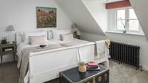 Bedroom six is a light-filled, second-floor twin room with two large single beds