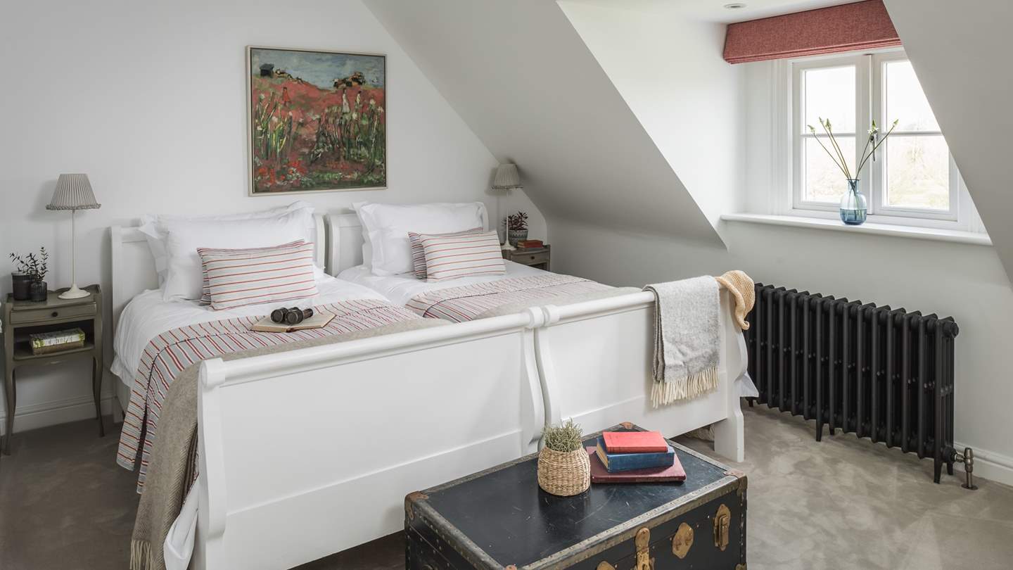 Bedroom six is a light-filled, second-floor twin room with two large single beds